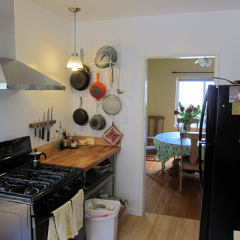 Butcher block work area near stove