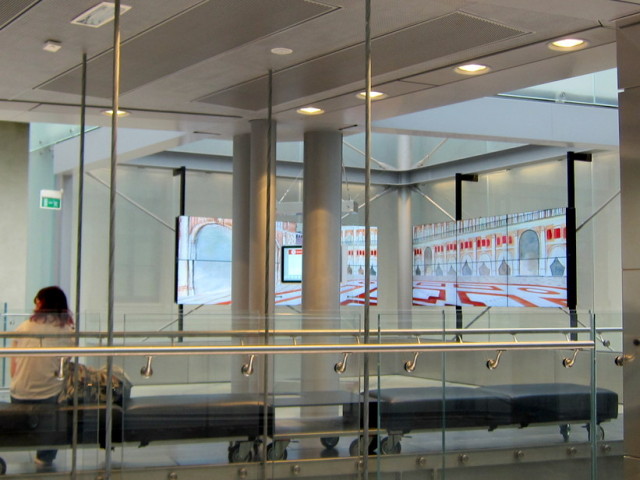 The architecture inside, stainless steel, cables glass - continuous video panel along the wall
