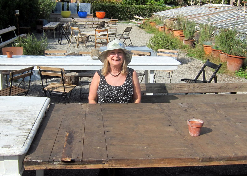There's that woman again! Seated at a table made from a big old door.