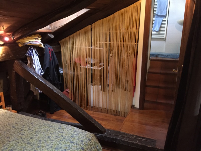 hanging strands serve as a curtain for the "armadio" - clothes closet